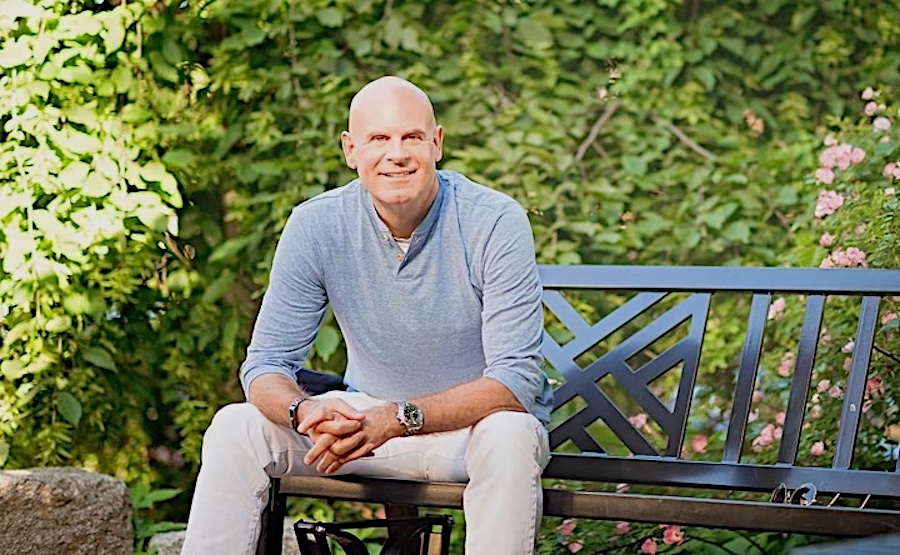 Jeffrey Rediger seated in a garden